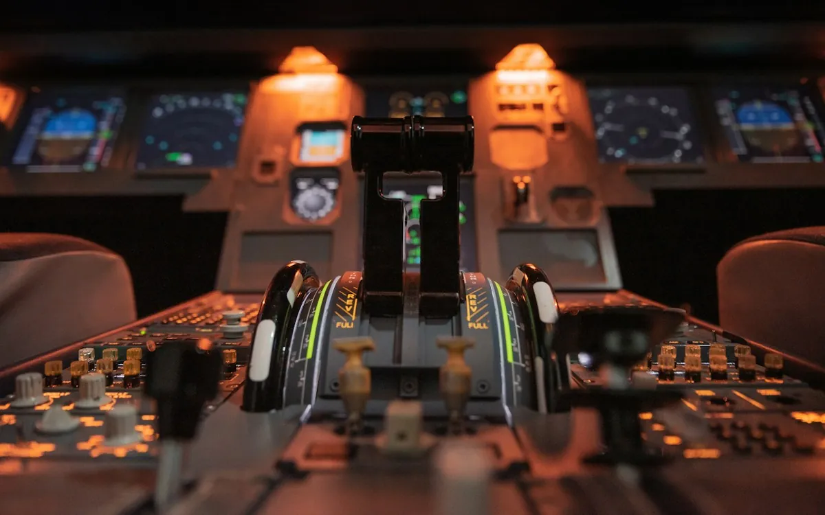 Throttle levers and instrument panels in an aircraft cockpit, the industry where the AICC standard began