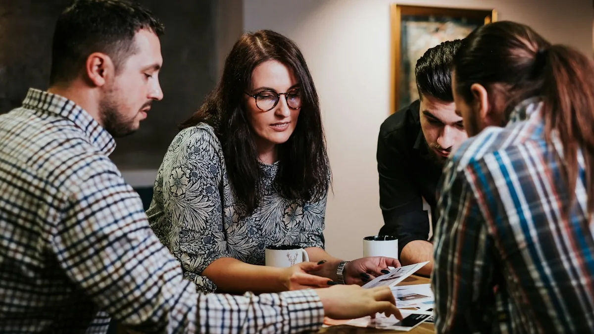 A small team at a wooden table reviewing printed course documents together