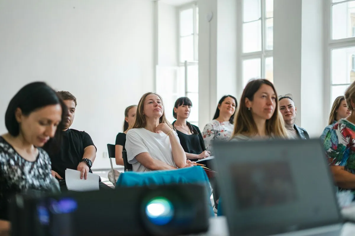 Employees listening during a corporate training workshop in a bright room