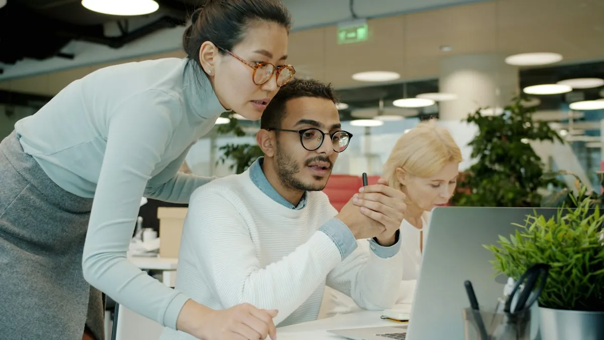 Two LMS administrators checking migrated courses on a computer screen