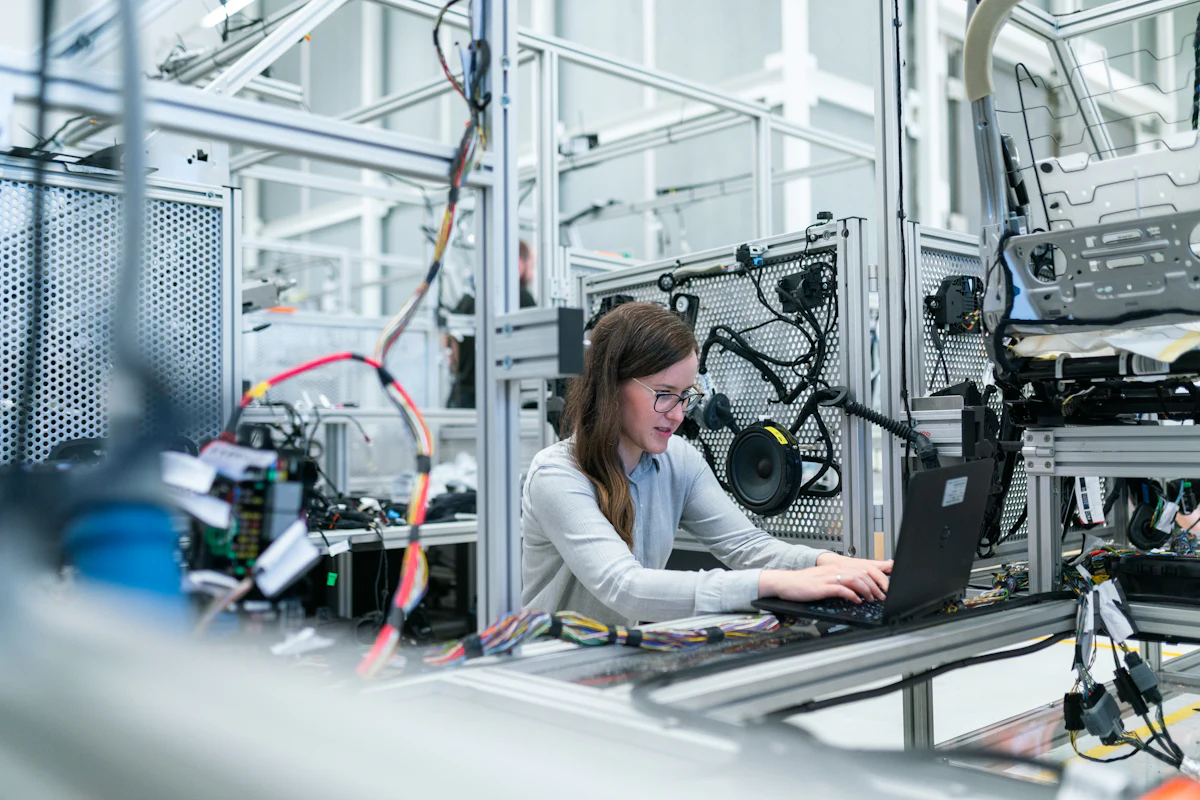 Manufacturing plant employee working with production equipment